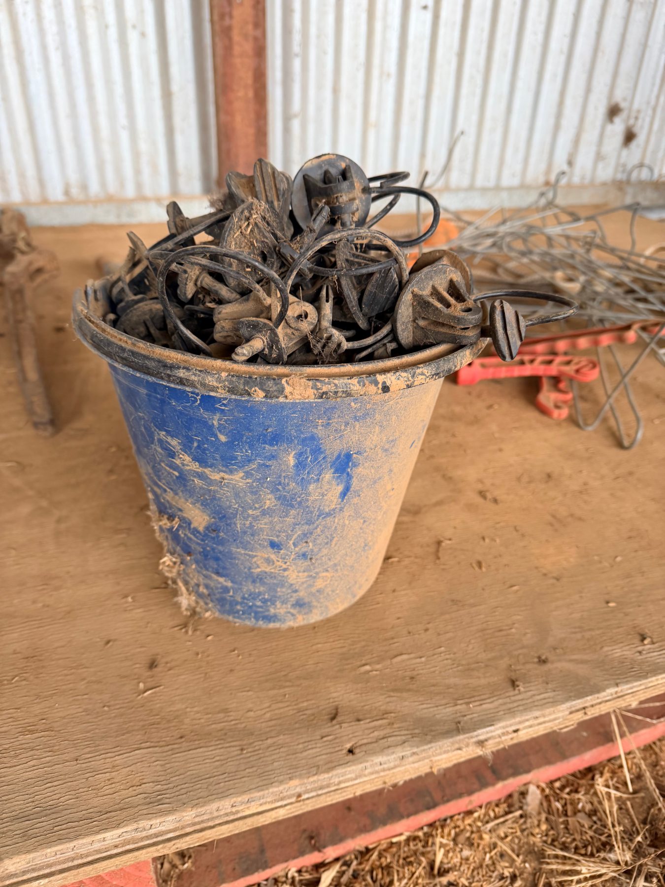 Bucket of electric fence insulators, stand-offs and insulated handles - photo 2