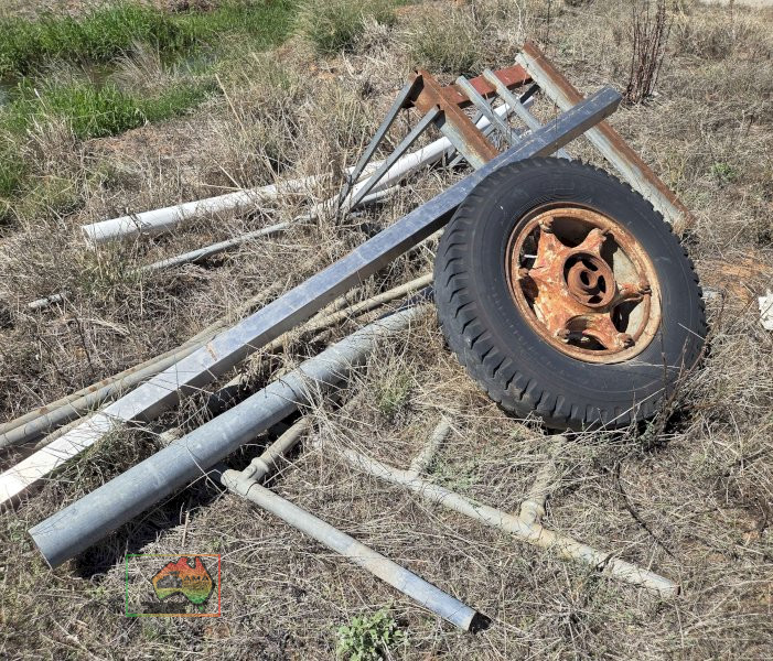 Assorted scrap steel and old truck wheel