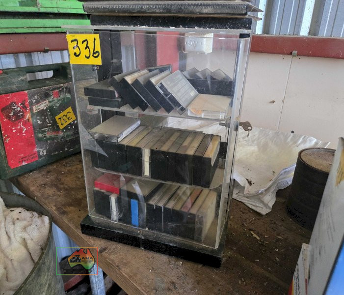 Assorted Music Cassette Tapes in Storage Cabinet
