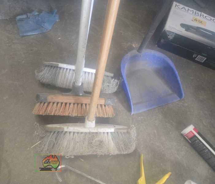 Assorted brooms and dustpan