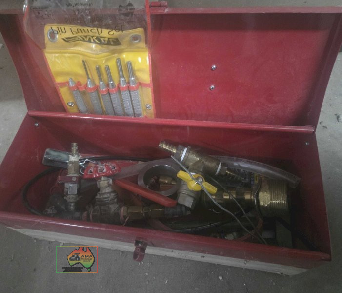 Toolbox with set of hole punches and assorted brass hose fittings