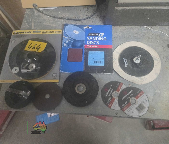 Assorted grinder wheels and sanding discs in steel tray