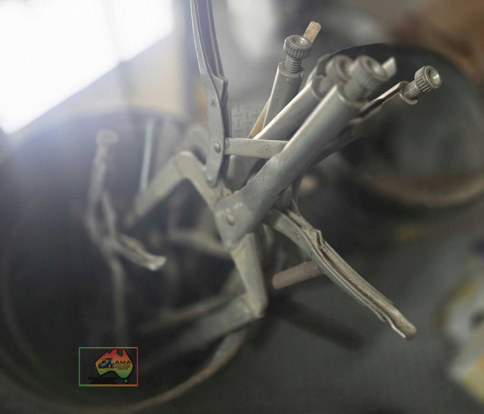 Bucket of metal spring clamps
