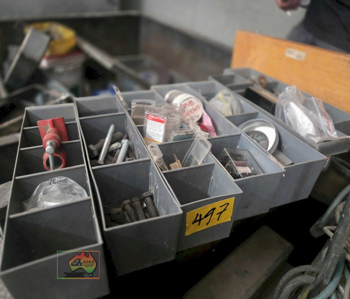 7 grey storage containers full of assorted nuts, bolts, screws, and sundries