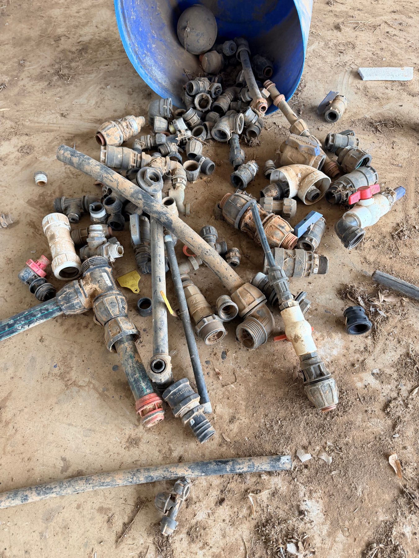 Storage tub of assorted irrigation fittings and valves - photo 1