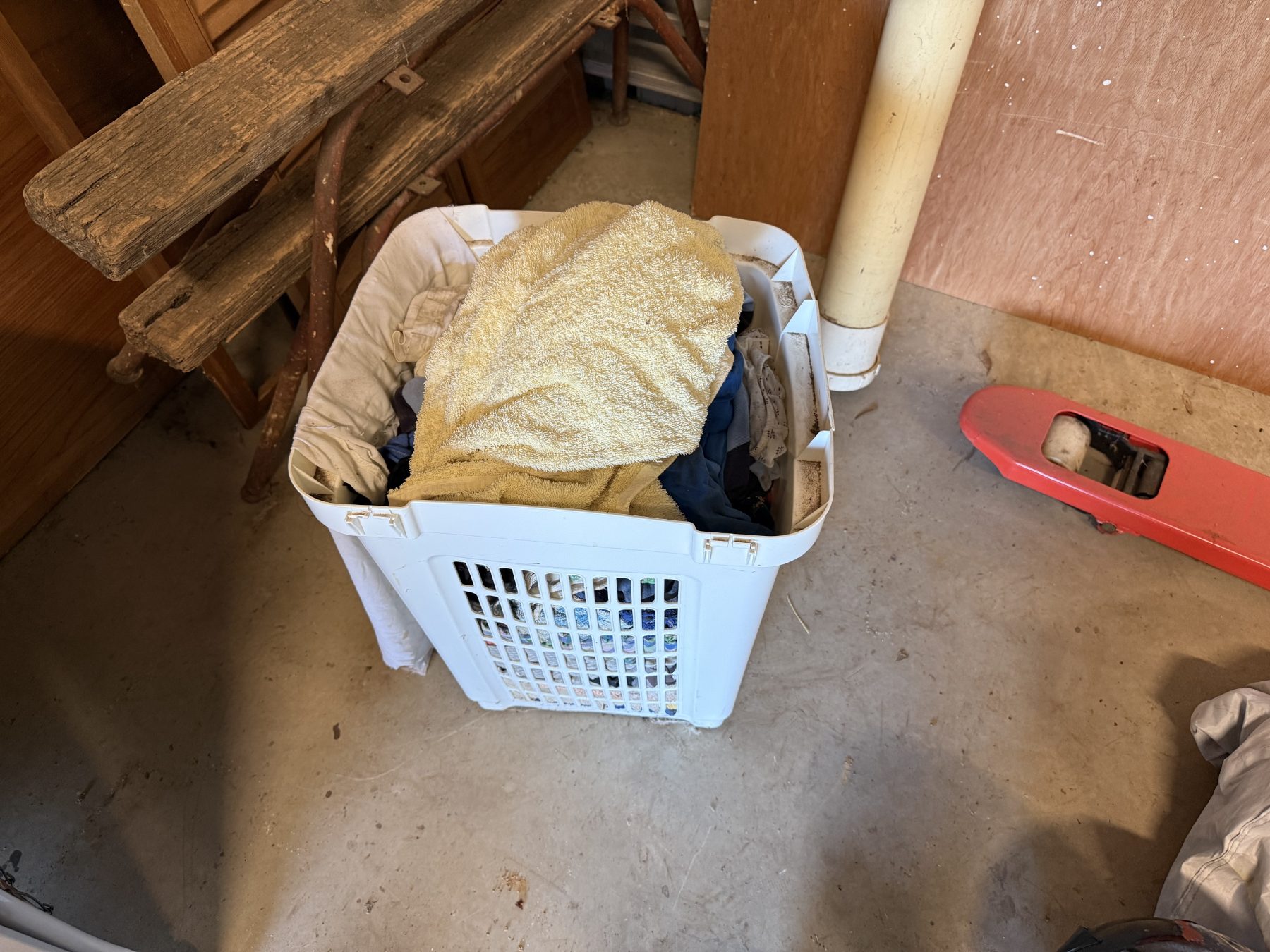 Washing basket full of towels, sheets, and rags