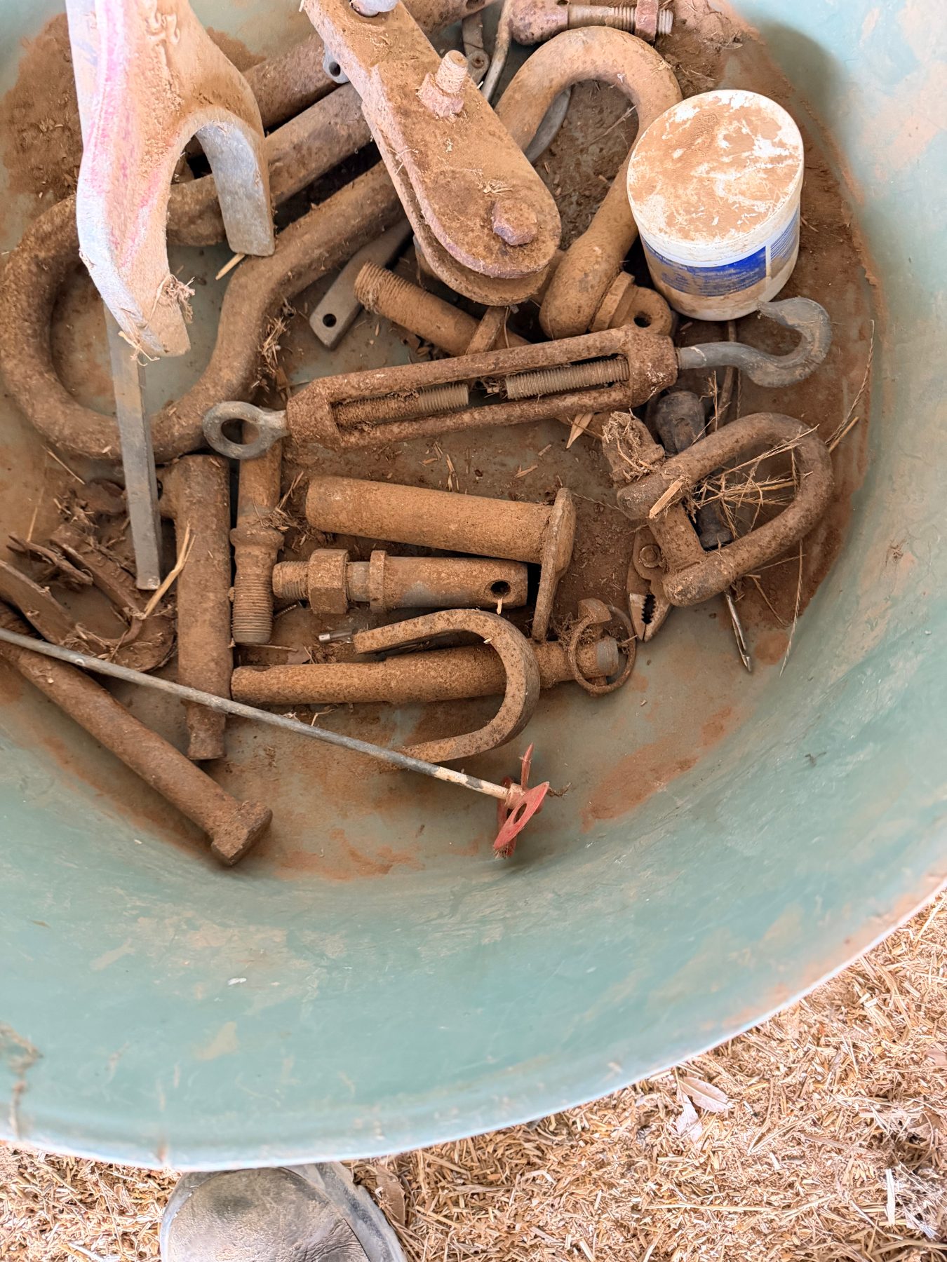 Storage tub of assorted tractor pins, shackles, paint stirrer, and logging pear - photo 2