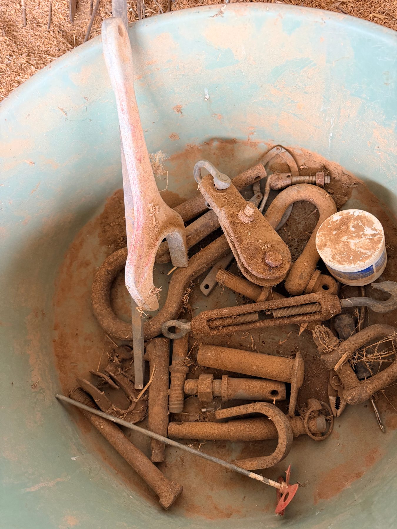 Storage tub of assorted tractor pins, shackles, paint stirrer, and logging pear - photo 3