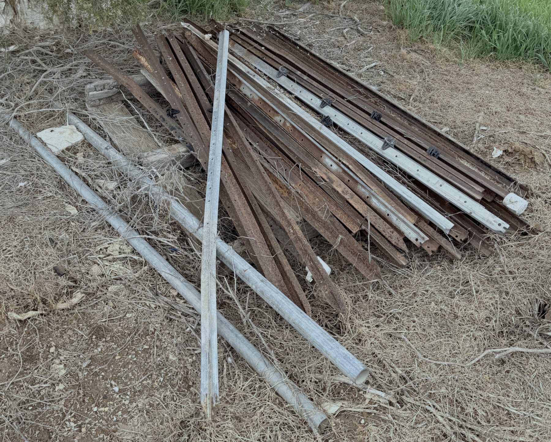 Bundle of steel posts and 2 lengths of scrap steel