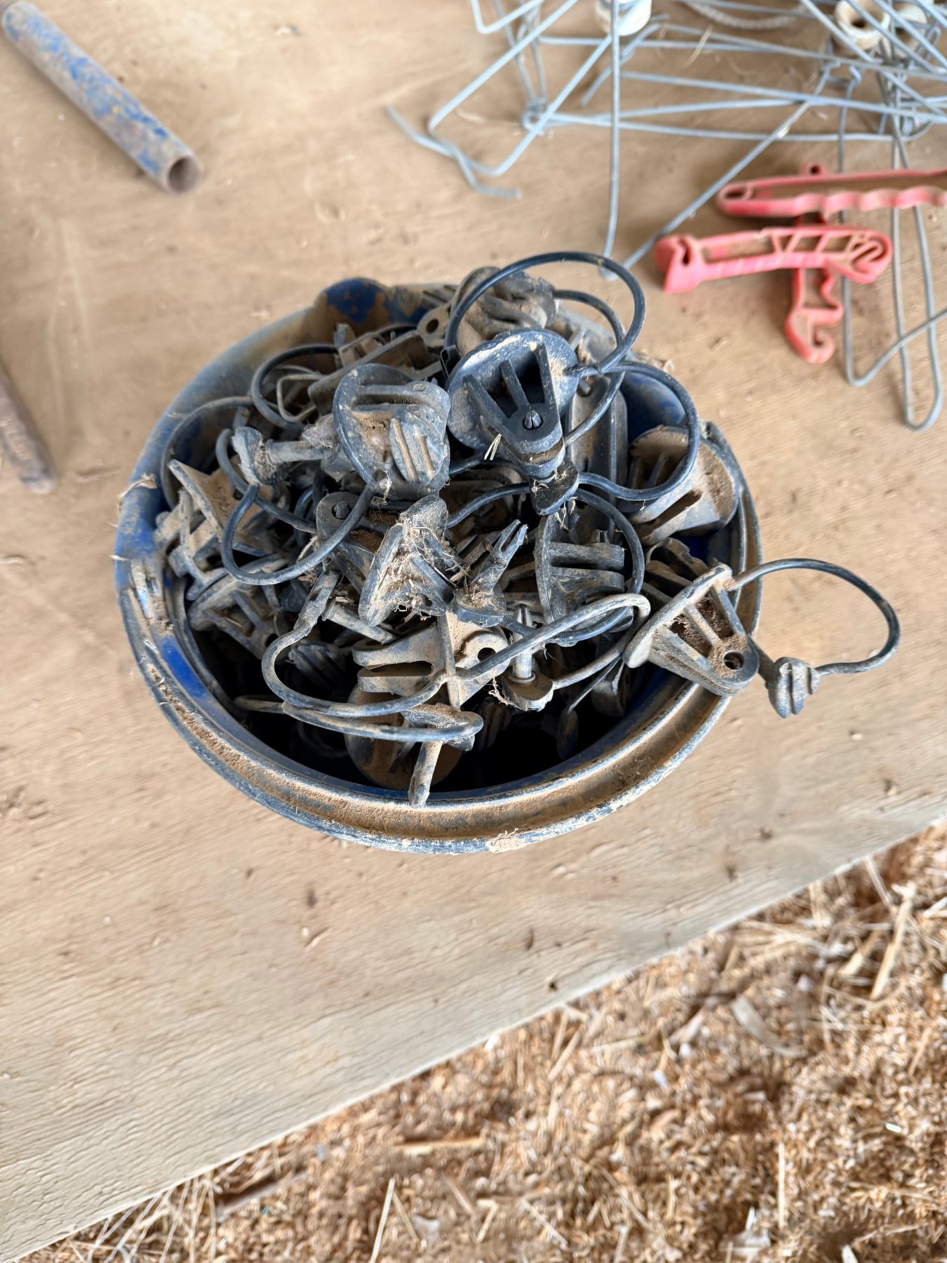 Bucket of electric fence insulators, stand-offs and insulated handles - photo 1