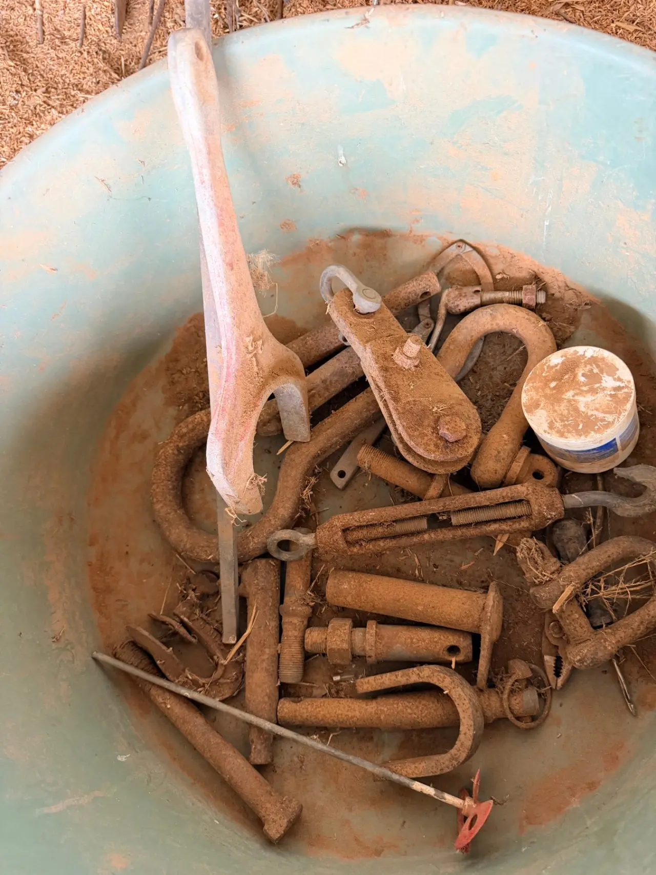 Storage tub of assorted tractor pins, shackles, paint stirrer, and logging pear - photo 3