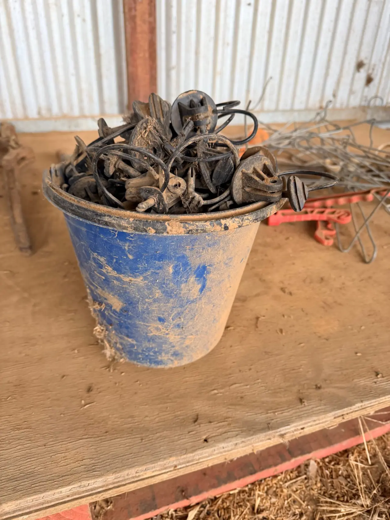 Bucket of electric fence insulators, stand-offs and insulated handles - photo 2