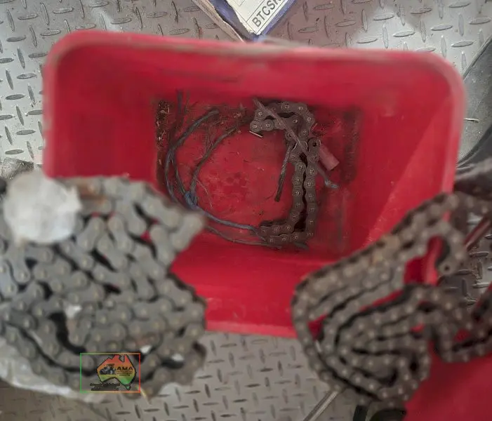 Bucket with assorted sprocket/gear chains - photo 1