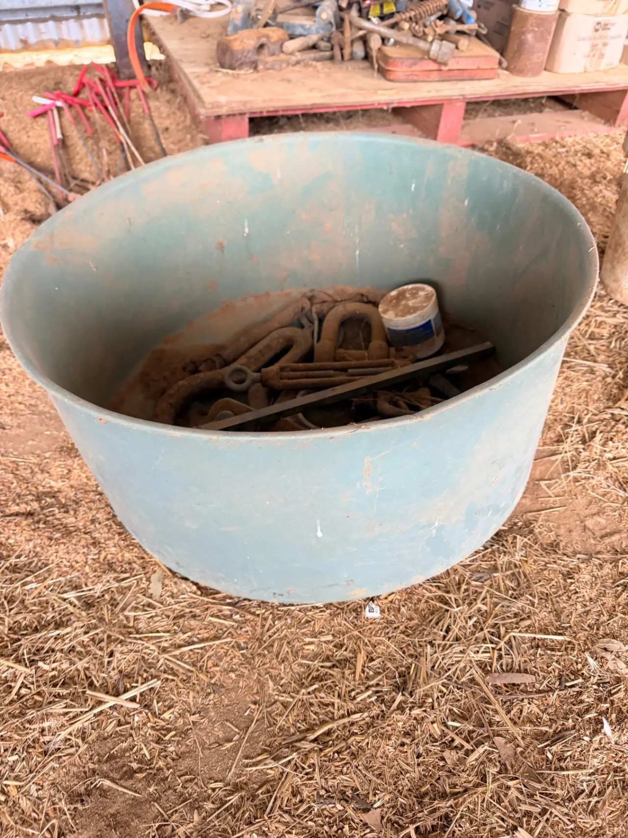 Storage tub of assorted tractor pins, shackles, paint stirrer, and logging pear - photo 1